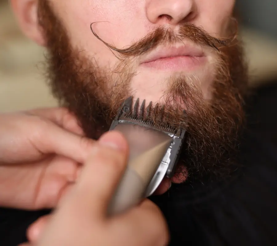 Master barber performing a precision beard trim with clippers in Sioux Falls SD