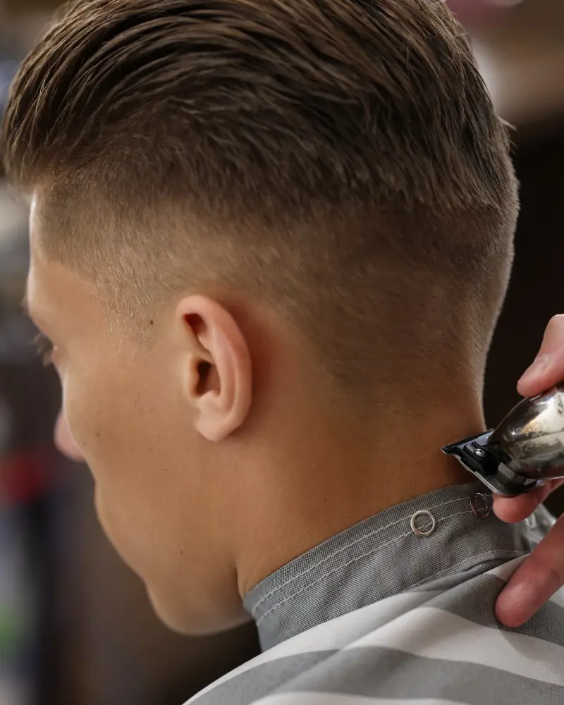 Barber executing a sharp razor line up on a client in Sioux Falls